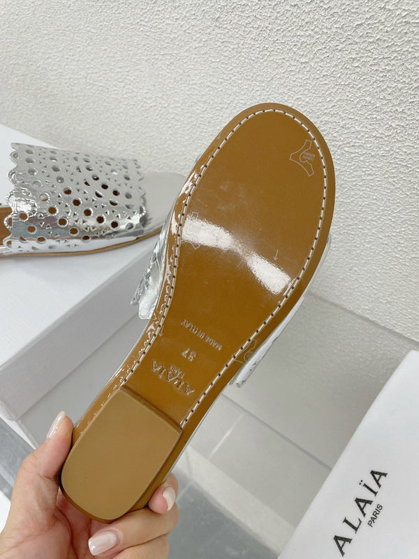 ALAIA VIENNE FLAT MULES IN SILVER LAMBSKIN