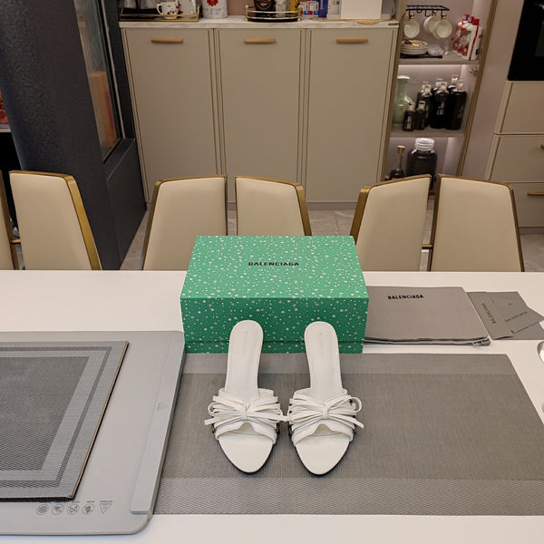BOW-EMBELLISHED HIGH MULES IN WHITE SHEEPSKIN